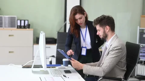 Two business workers talking on the smartphone and using laptop Video stock 312981680