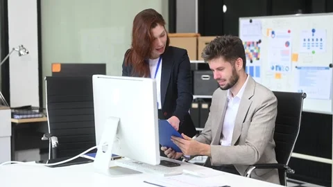 Two business workers talking on the smartphone and using laptop Video stock 312981686