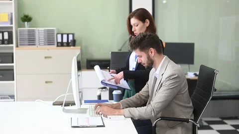 Two business workers talking on the smartphone and using laptop Video stock 312981694