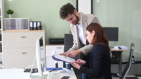 Two business workers talking on the smartphone and using laptop Video stock 312981695