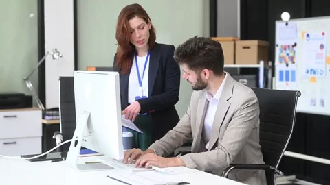 Two business workers talking on the smartphone and using laptop Video stock 312981699