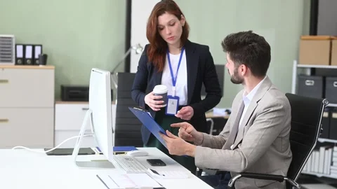 Two business workers talking on the smartphone and using laptop Video stock 312981702