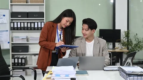 Two business workers talking on the smartphone and using laptop at office. Stock Footage 313706288
