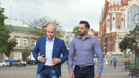 Two businessman are walk while talking. City background Stock Footage