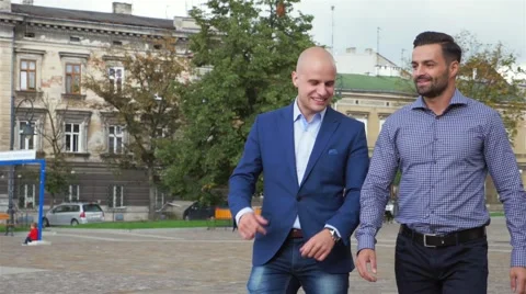 Two businessman are walk while talking. City background Stock Footage