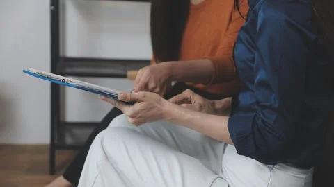 Two Businessman Calculating Bills Using Calculator At Workplace. Business t.. Stock Footage 328995831