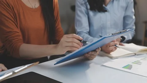 Two Businessman Calculating Bills Using Calculator At Workplace. Business t.. Stock Footage 328996409