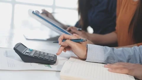 Two Businessman Calculating Bills Using Calculator At Workplace. Business t.. Stock Footage 328996474