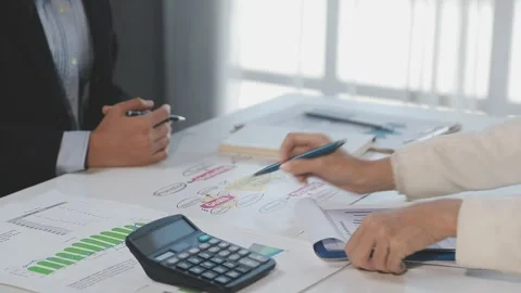 Two Businessman Calculating Bills Using Calculator At Workplace. Business t.. Stock Footage 328996589