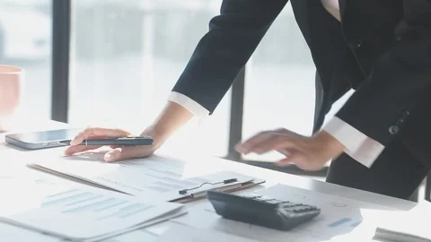 Two Businessman Calculating Bills Using Calculator At Workplace. Business t.. Stock Footage 328996882