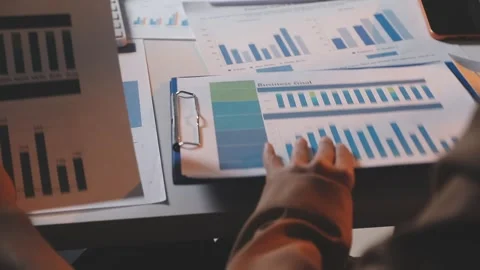 Two Businessman Calculating Bills Using Calculator At Workplace. Business t.. Stock Footage 328996932