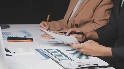 Two Businessman Calculating Bills Using Calculator At Workplace. Business t.. Stock Footage 328997022