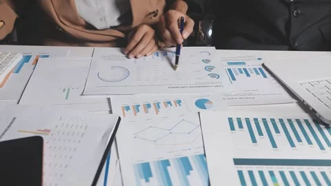 Two Businessman Calculating Bills Using Calculator At Workplace. Business t.. Stock Footage 328997339