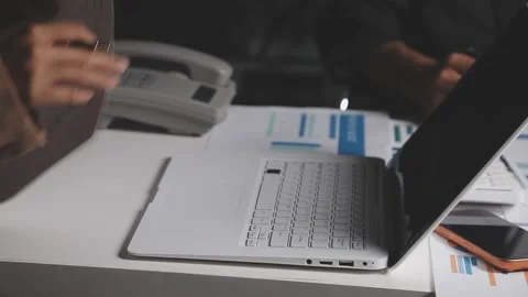 Two Businessman Calculating Bills Using Calculator At Workplace. Business t.. Stock Footage 328997405