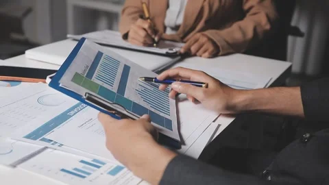 Two Businessman Calculating Bills Using Calculator At Workplace. Business t.. Stock Footage 328997428