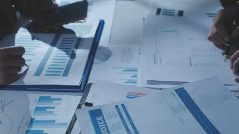 Two Businessman Calculating Bills Using Calculator At Workplace. Business t.. Stock Footage 328997622