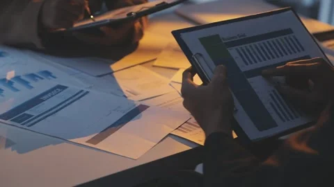 Two Businessman Calculating Bills Using Calculator At Workplace. Business t.. Stock Footage 328997687