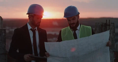 Two businessman s analyzing the map of construction , discussion , wearing Video stock 93586601