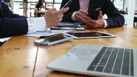Two businessman in suit using smartphone at table in loft design cafe. Stock Footage 118347943