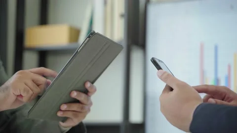 Two businessman using smartphone and tablet in the office.4K Resolution. Stock Footage 149804780