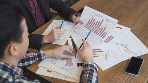 Two businessmen analyze the graphs Stock Footage 86489413