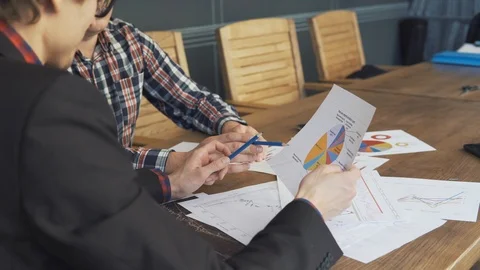 Two businessmen analyze the graphs Stock Footage 86489461