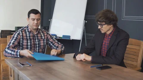 Two businessmen analyze the graphs Stock Footage 86489464