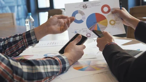 Two businessmen analyze the graphs Stock Footage 86489712