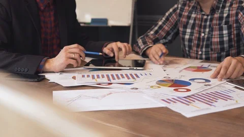 Two businessmen analyze the graphs Stock Footage 86489838