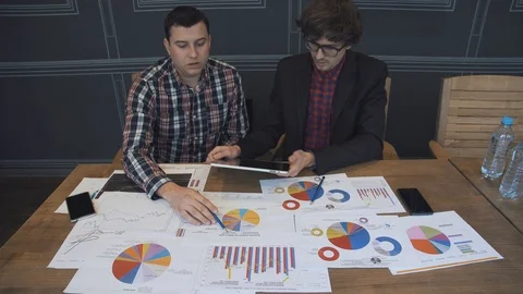 Two businessmen analyze the graphs Stock Footage 86490193