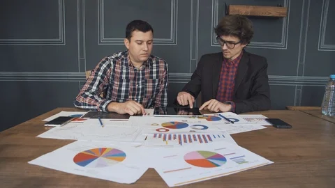 Two businessmen analyze the graphs Stock Footage 86490254