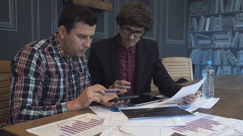 Two businessmen analyze the graphs Stock Footage 86490257