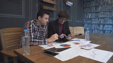Two businessmen analyze the graphs Stock Footage 86490301
