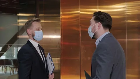 Two businessmen avoid a handshake when meeting and greet with elbows bumping. Stock Footage 151285893