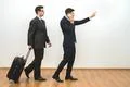 The two businessmen with a bag phone and gesture on the white wall background Photo