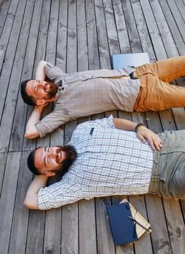 A two businessmen in a break between work. He relaxes looking into the sky Stock Photos