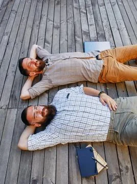 A two businessmen in a break between work. He relaxes looking into the sky Stock Photos