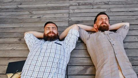 A two businessmen in a break between work. He relaxes looking into the sky Stock Photos