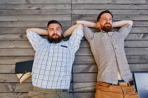 A two businessmen in a break between work. He relaxes looking into the sky Stock Photos