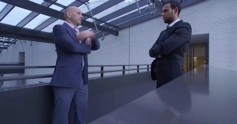 Two Businessmen Chatting In a Corridor Stock Footage 123512960