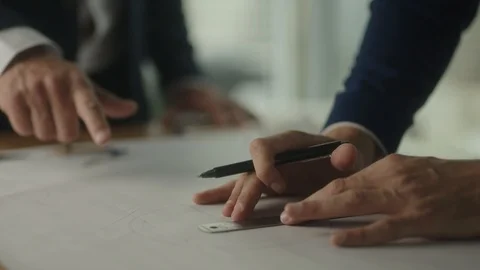 Two businessmen create blueprint in office with view on downtown LA Видео 127412541