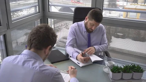 Two businessmen, discussing, analyzing, plan of meeting, in work, office Video stock 73224924
