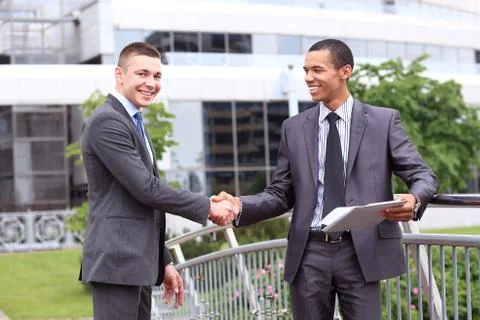 Two Businessmen Discussing Document Outside Office Foto stock