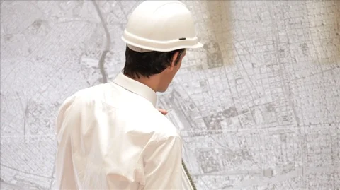 Two businessmen discussing a large map. Stock Footage 88343022