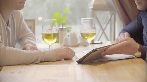 Two businessmen discussing project on the tablet at the bar Stock Footage 72618631