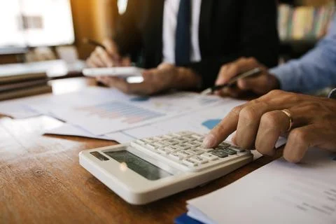Two businessmen discussion analysis sharing calculations about the company .. Stock Photos