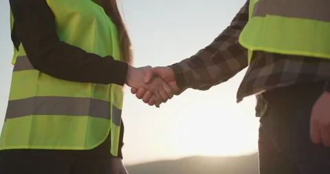 Two businessmen engineers shaking hands. Two engineers in hardhats shake hands Stock Footage 195251475