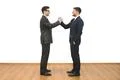 The two businessmen greeting on the white wall background Photo