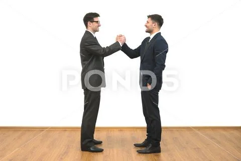 The two businessmen greeting on the white wall background Stock Photos