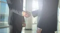 The two businessmen handshake in the office hall. slow motion 4k or 4k+ Resolution